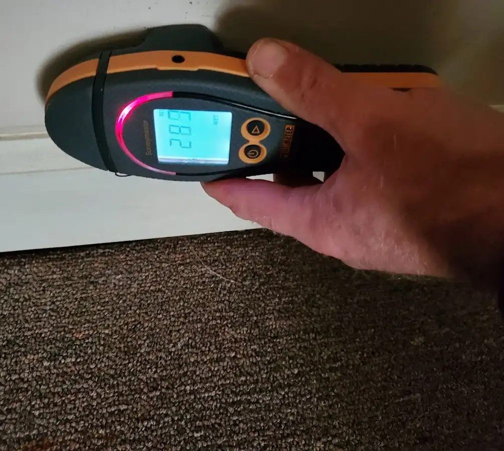 Moisture detection at baseboard during Storm Damage Restoration in Santa Ana
